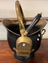 Brass helmet shaped coal scuttle with swing handle and shovel. (B.P. 21% + VAT)