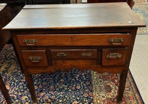 Early 19th century oak lowboy, the moulded top above an arrangement of four drawers with shaped