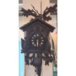 20th century carved wooden stained Bavarian Cuckoo Clock with weight, chains and pendulum. (B.P. 21%