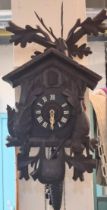 20th century carved wooden stained Bavarian Cuckoo Clock with weight, chains and pendulum. (B.P. 21%
