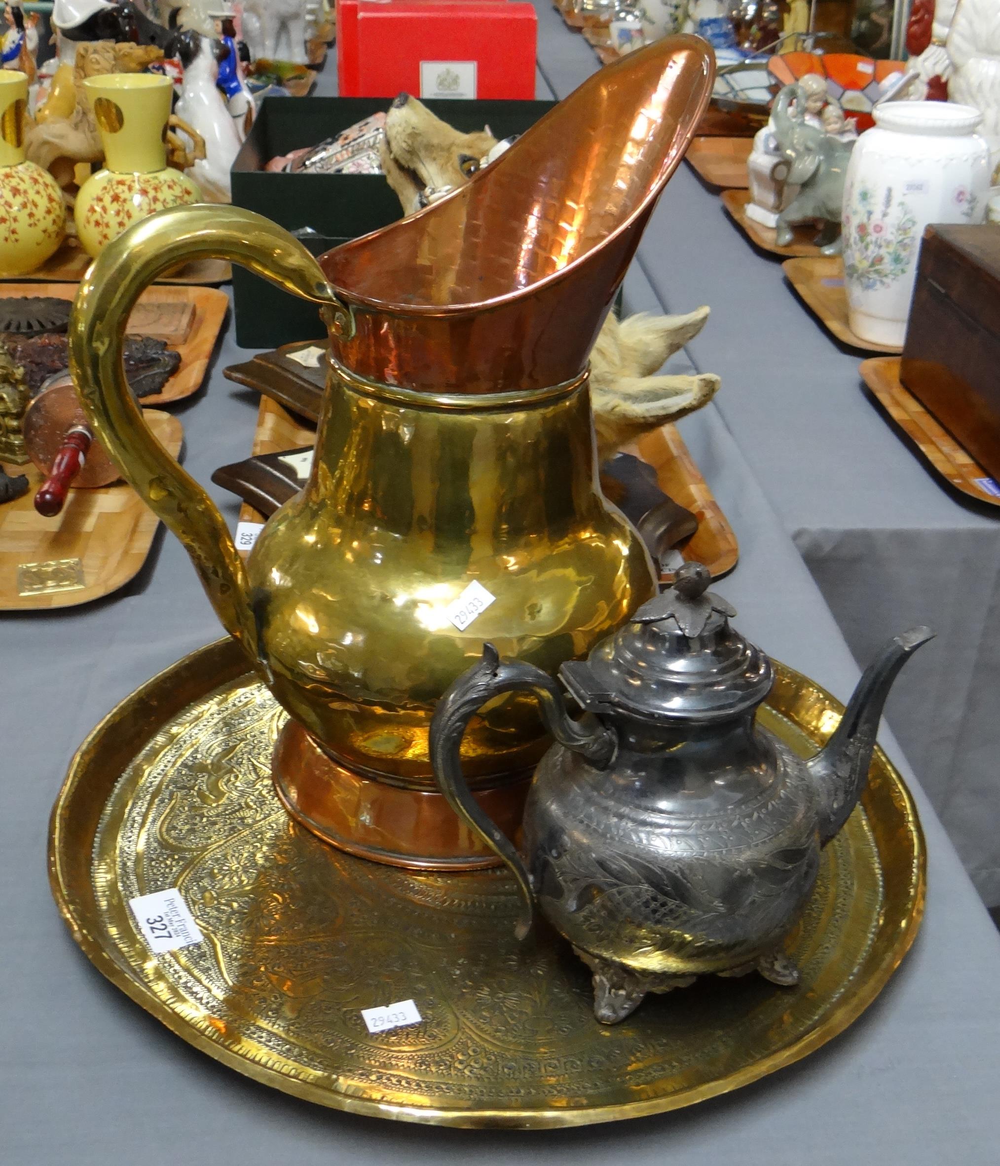 Middle Eastern design embossed brass circular tray containing a brass and copper ewer and a metal