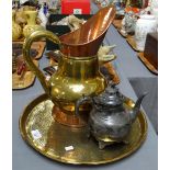 Middle Eastern design embossed brass circular tray containing a brass and copper ewer and a metal