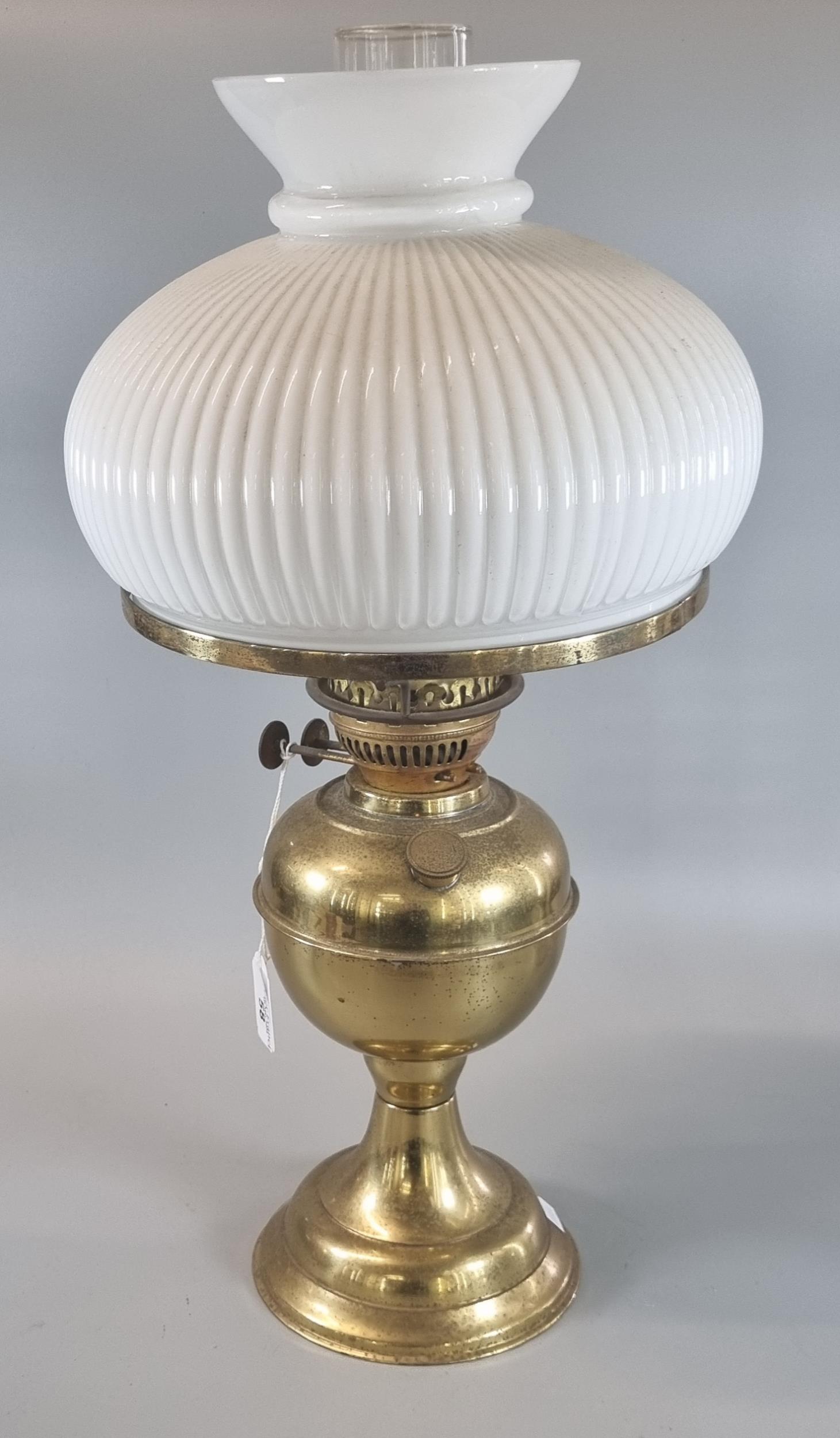 20th century double oil burner lamp with opaline glass fluted shade on a brass reservoir and