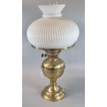 20th century double oil burner lamp with opaline glass fluted shade on a brass reservoir and