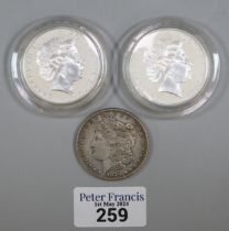 Queen Elizabeth II silver one Dollar piece dated 2000 (2), together with an 1879 USA silver