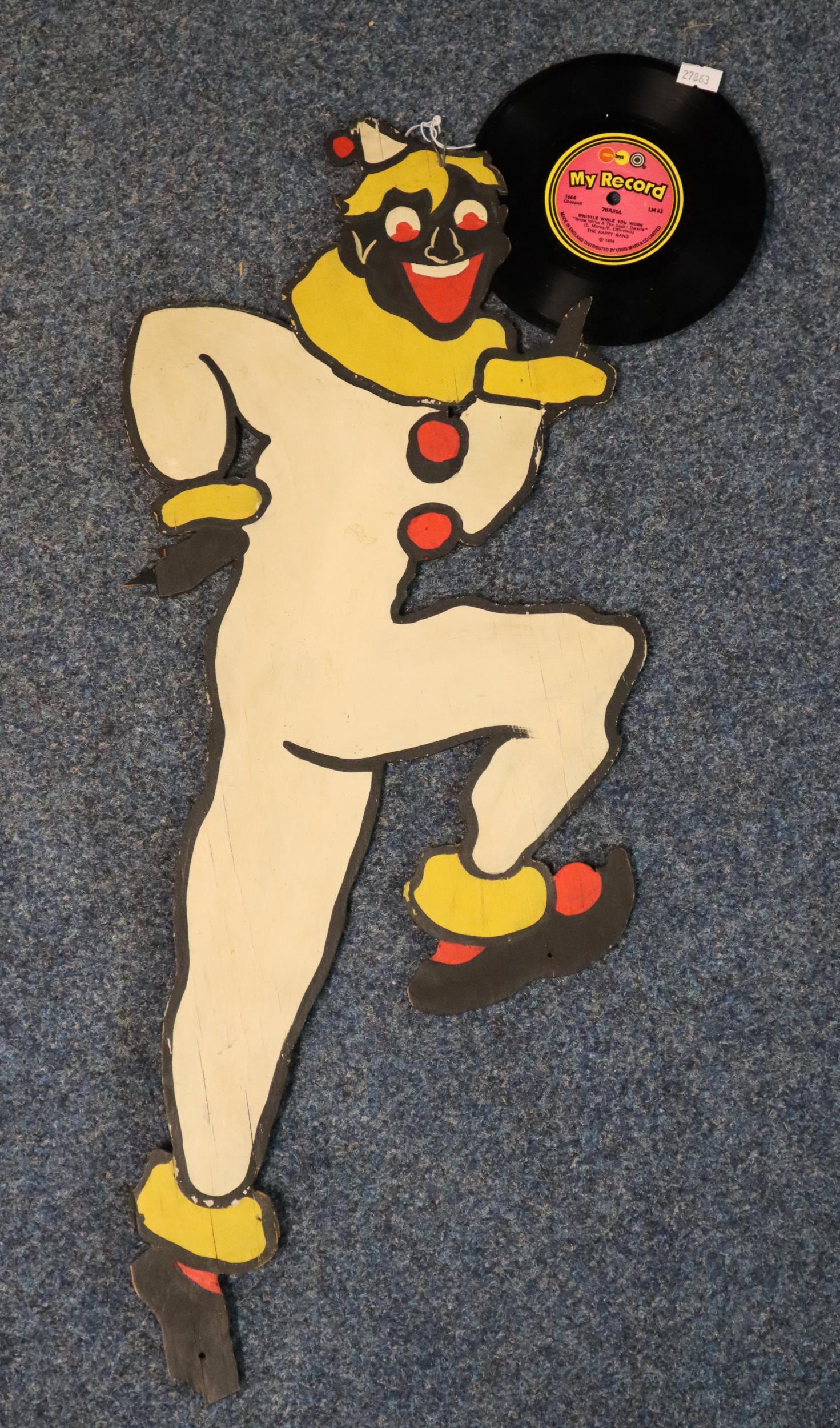 Printed/painted carboard clown figure holding a 1974 vinyl record 'Whistle while you work' by The