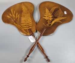 Pair of Mauchline Ware hand held fans, decorated to the front and back with ferns, and having turned