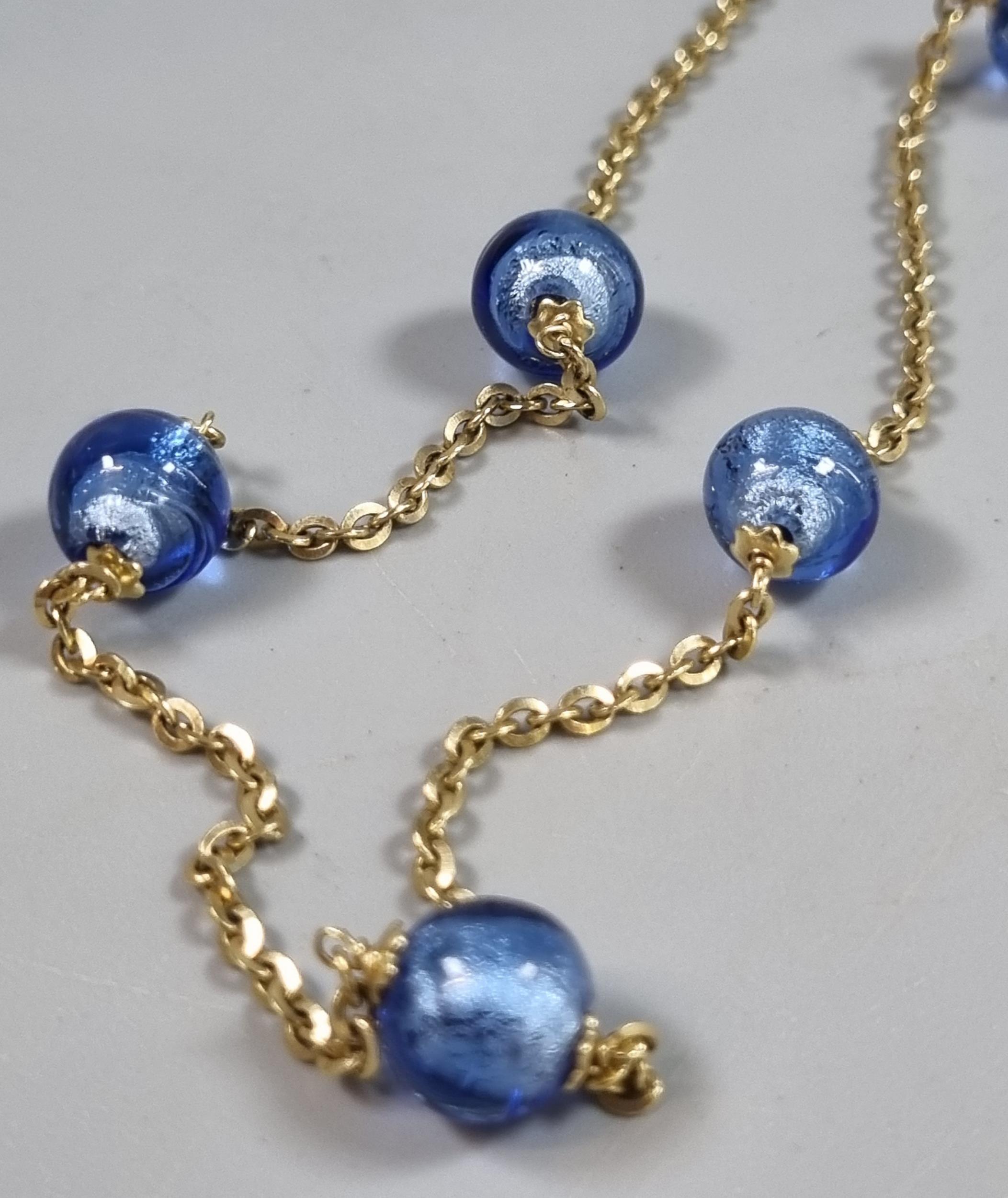 9ct gold chain with blue glass beads. 13.3g approx. (B.P. 21% + VAT)