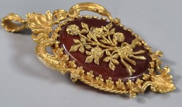 Victorian carnelian pendant in floral hallmarked 9ct gold mount. 20g approx. (B.P. 21% + VAT)