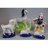 Collection of Staffordshire and Staffordshire style figures to include: recumbent sheep. zebra, goat