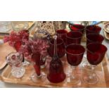 Collection of ruby and cranberry glass items to include: wine glasses, brandy goblets, bell, pair of