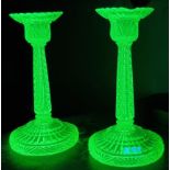 Pair of uranium glass moulded candlesticks together with a blue glass mallet shaped decanter and