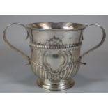 18th century silver two handled porringer, with fluted repoussé decoration and central vacant