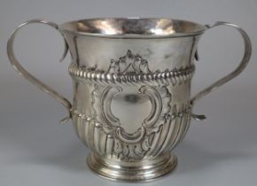 18th century silver two handled porringer, with fluted repoussé decoration and central vacant