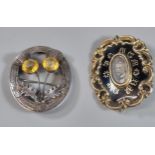 Early Victorian black enamel and yellow metal mourning brooch together with a silver Scottish