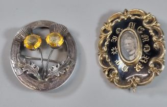 Early Victorian black enamel and yellow metal mourning brooch together with a silver Scottish
