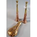 Pair of copper and brass hunting horns, together with a copper and brass powder flask with relief