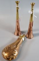 Pair of copper and brass hunting horns, together with a copper and brass powder flask with relief