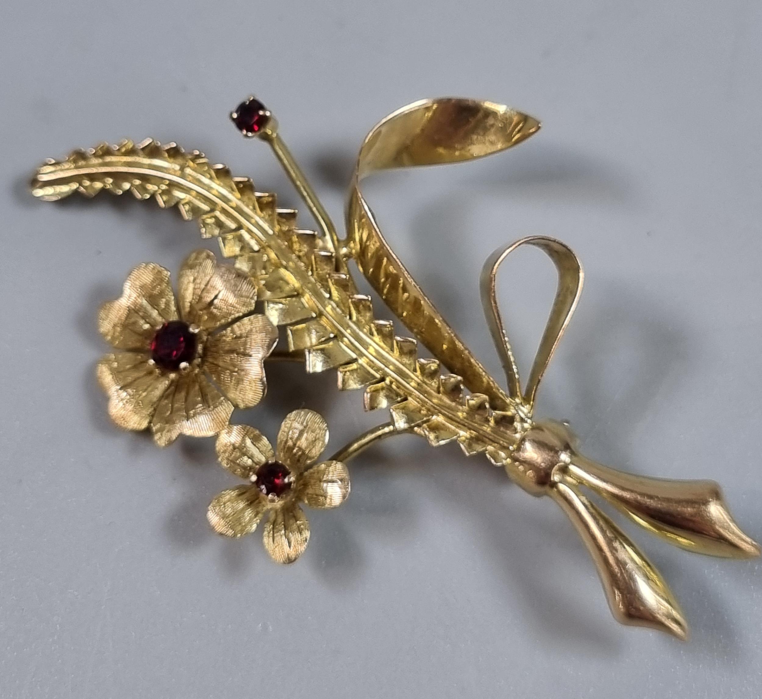 9ct gold floral and foliate brooch inset with rubies. 5.3g approx. (B.P. 21% + VAT)