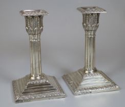 Pair of late Victorian silver Corinthian column candlesticks with acanthus leaf moulded decoration