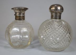 Two silver topped and glass scent bottles of globular form. (2) (B.P. 21% + VAT)