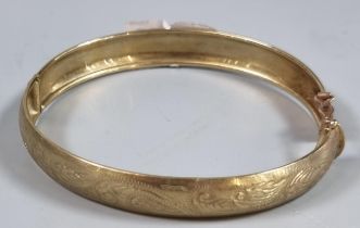 9ct gold engraved bangle. 7.8g approx. (B.P. 21% + VAT)