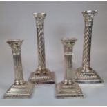 Two similar late Victorian silver Corinthian Column candlesticks dated 1899 and 1900 together with