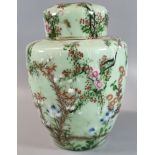 Japanese export, polychrome on celadon ground 'Seto' jar and cover, decorated with prunus flowers,