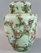 Japanese export, polychrome on celadon ground 'Seto' jar and cover, decorated with prunus flowers,