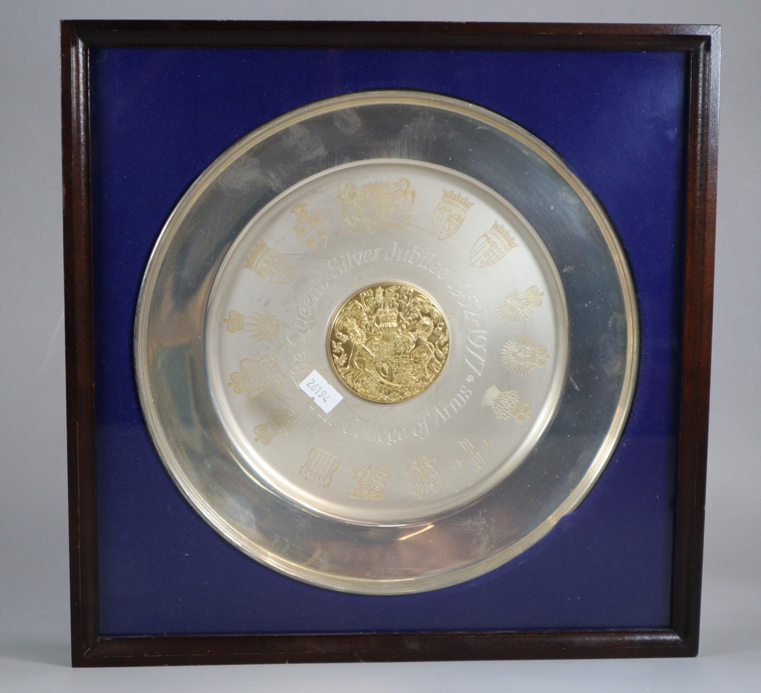 Commemorative Elizabeth II silver circular dish with central raised gilt roundel and coat of arms,