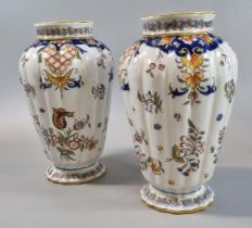 Pair of Italian Faience vases of ribbed design with flowers and foliage. 20.5cm high approx. (B.P.