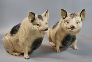 Pair of pottery seated Wemyss style pigs. 19.5cm high approx. (2) (B.P. 21% + VAT) One of the pigs