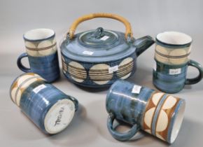 Troika Pottery teapot with bamboo handle and single band of circles, together with a set of four