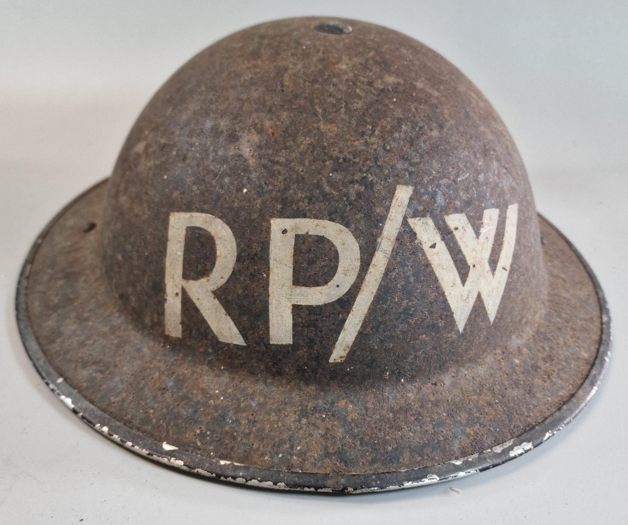 WWII British Brodie MK.II helmet. Marked 'RP/W' (Repair Party/Water). Stamped 'BMB 1939'. With liner