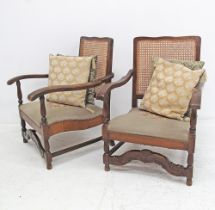 A pair of carved walnut open armchairs