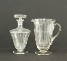 An engraved glass pitcher and a decanter