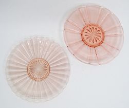 A near pair of pink pressed glass cake platters