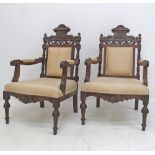 Carved walnut open armchairs