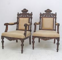 Carved walnut open armchairs