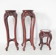 A set of three Chinese style carved wooden stands
