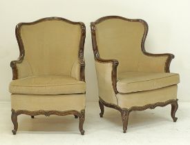 A pair of Louis XV style carved mahogany wing bergeres