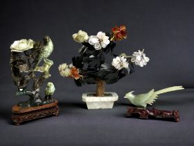 A collection of Chinese carved jade & hardstone sculptures. Including a bird & flower group on