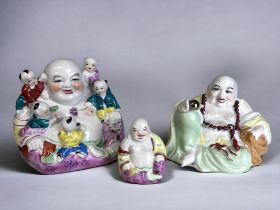 A COLLECTION OF THREE CHINESE PORCELAIN BUDDHAS. Including hand painted seated Buddha with five