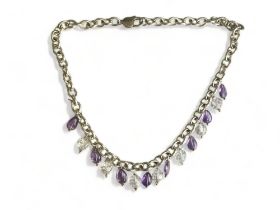 A LADIES STERLING SILVER NECKLACE. SET WITH PURPLE & CLEAR CRYSTAL DROPS. GROSS WEIGHT - 70.7G