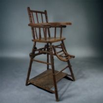 A 19TH CENTURY FRENCH CHILDS CHAIR. Folds down to walker. With original wheels.