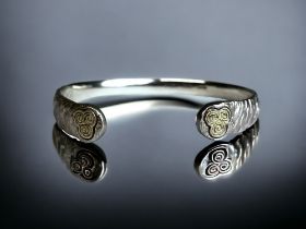 A STERLING SILVER LADIES BANGLE. With gilt stylised Celtic type design naturalistic finish. 925 & '