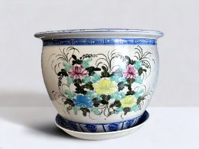 A LARGE VIETNAMESE HAND PAINTED PLANTER. Foliate design, with blue trim. Together with a similar