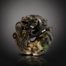 A CHINESE CARVED HARDSTONE DRAGON. Openwork circular Dragon with Pearl. Diameter - 5.5cm