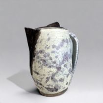 AN UNUSUAL STUDIO POTTERY JUG & COVER. With applied & painted spout & knop. Unmarked. Height - 20cm