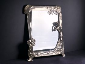 An Arts & crafts "The first Cuckoo" style silver plate mirror. In the manner of WMF, but unmarked.